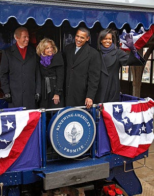 Joe Biden, Jill Biden, Barack Obama and Michelle Obama wave to members of the news media after boarding their antique Pullman Georgia 300 train car in Wilmington, Delaware, January 17, 2009