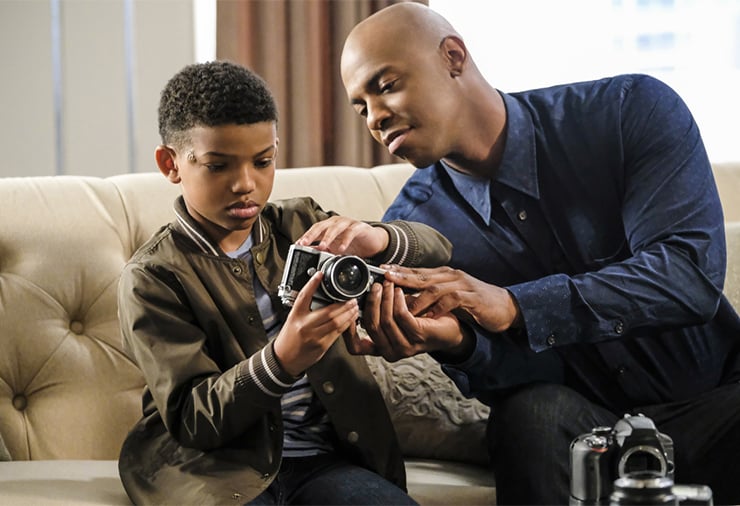 Marcus and James examining old cameras.