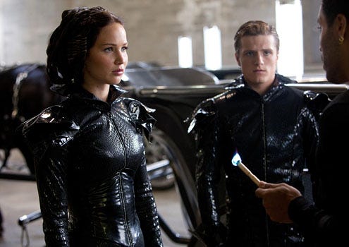The Hunger Games - Jennifer Lawrence as Katniss Everdeen, Josh Hutcherson as Peeta Mellark and Lenny Kravitz as Cinna