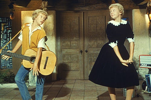 The Parent Trap - Hayley Mills, left, as Susan Evers (with the guitar) and Hayley Mills, right, as Sharon McKendrick (in the dress).