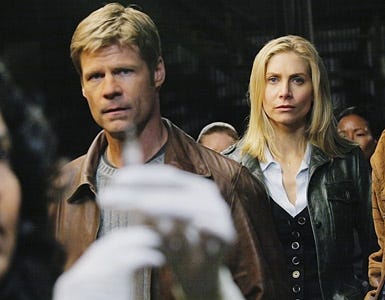 V - Joel Gretsch as Father Jack Landry and Elizabeth Mitchell as Erica Evans