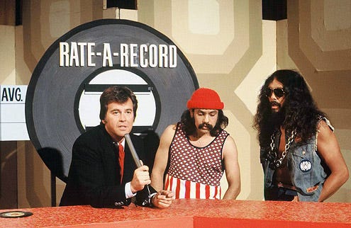 Dick Clark, Cheech Marin and Tommy Chong of "Cheech and Chong" - during the Rate-a-Record segment of "American Bandstand", February 26, 1976