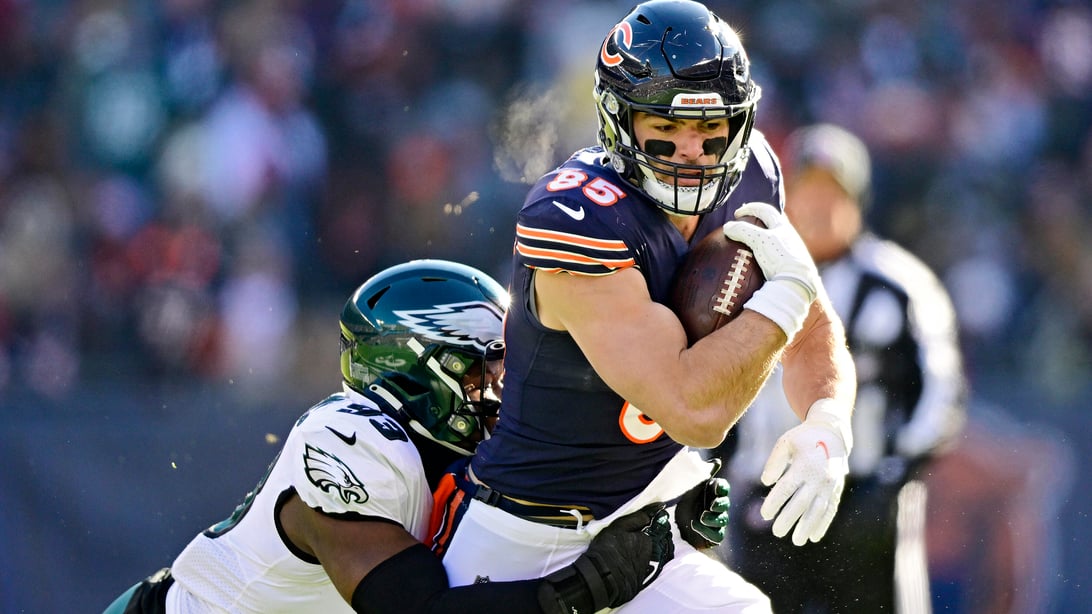 CHICAGO, ILLINOIS - DECEMBER 18: Cole Kmet #85 of the Chicago Bears is tackled by Milton Williams #93 of the Philadelphia Eagles during the first quarter at Soldier Field on December 18, 2022 in Chicago, Illinois.
