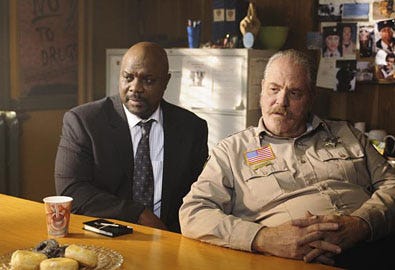 Happy Town - Season 1 - "In This Town on Ice" - Robert Wisdom as Roger Hobbes and M.C. Gainey as Sheriff Griffin Conroy