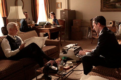 Mad Men - Season 3 - "Shut the Door. Have a Seat" - John Slattery and Jon Hamm; BACK: Vincent Kartheiser and Elisabeth Moss