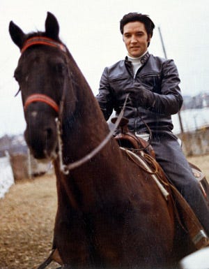 Elvis Presley - Riding a horse at his family home, 1968