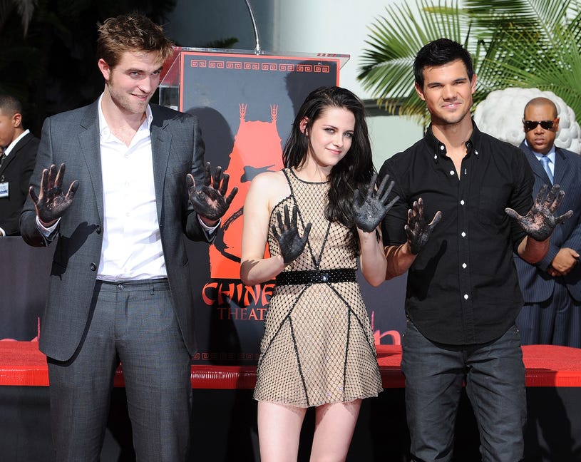 Robert Pattinson, Kristen Stewart and Taylor Lautner pose at "The Twilight Trio" Hand/Foorprint Ceremony at Grauman's Chinese Theatre on November 3, 2011