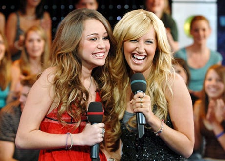 Miley Cyrus and Ashley Tisdale - on the set of MTV's "TRL", June 20, 2006